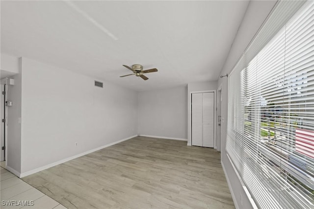 5032 Chiquita Blvd S Unit 101, Cape Coral, FL 33914 - empty room featuring a ceiling fan, baseboards, and light wood-style floors
