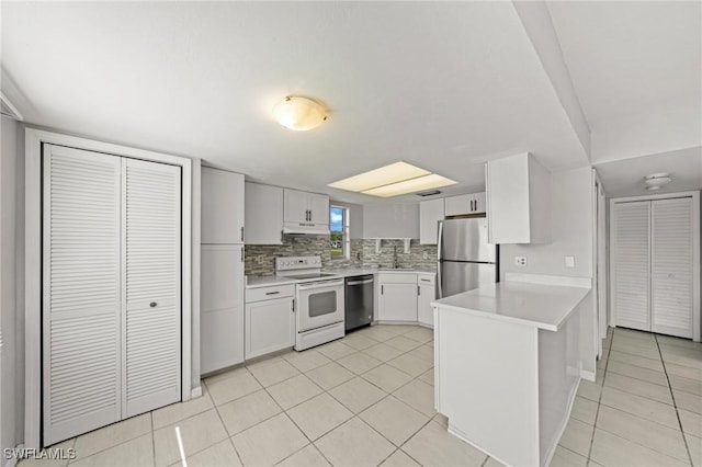 5032 Chiquita Blvd S Unit 101, Cape Coral, FL 33914 - kitchen with appliances with stainless steel finishes, a peninsula, light countertops, and light tile patterned floors