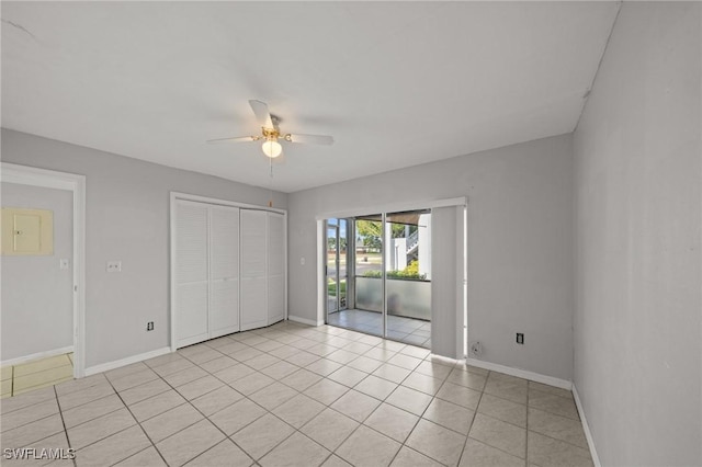 5032 Chiquita Blvd S Unit 101, Cape Coral, FL 33914 - unfurnished bedroom featuring access to exterior, light tile patterned floors, baseboards, a closet, and ceiling fan