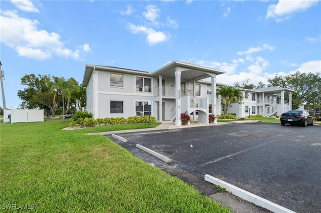 5032 Chiquita Blvd S Unit 101, Cape Coral, FL 33914 - view of front facade with uncovered parking, stucco siding, and stairway