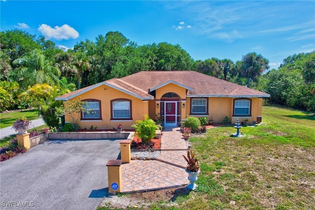 single story home with stucco siding and a front lawn
