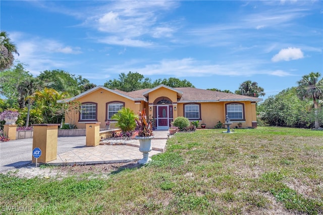 single story home with a front lawn and stucco siding