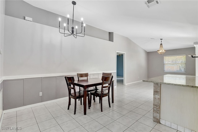 dining room with visible vents, light tile patterned flooring, an inviting chandelier, and lofted ceiling