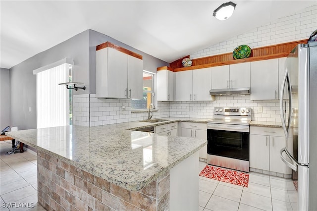 kitchen with a peninsula, light tile patterned flooring, under cabinet range hood, appliances with stainless steel finishes, and a sink