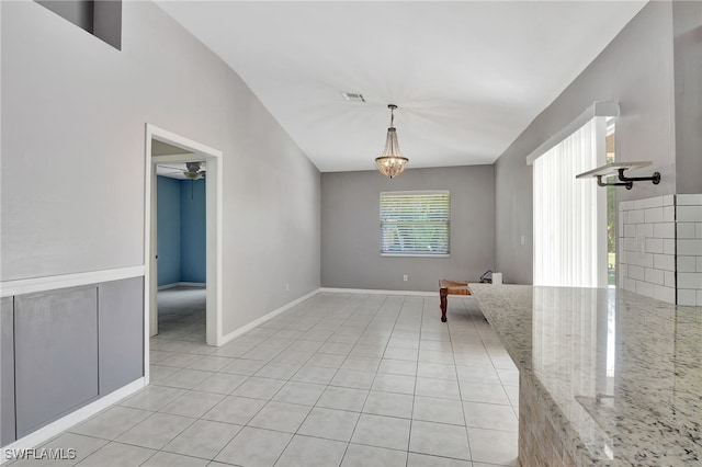 interior space with an inviting chandelier, light tile patterned floors, baseboards, and visible vents