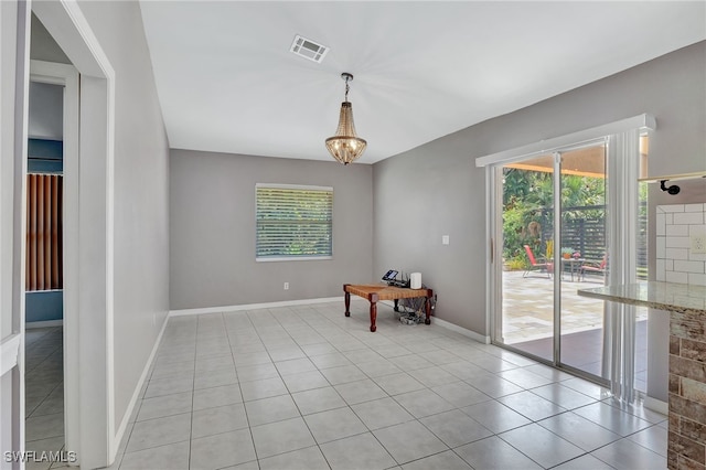 dining area with a chandelier, light tile patterned floors, visible vents, and baseboards
