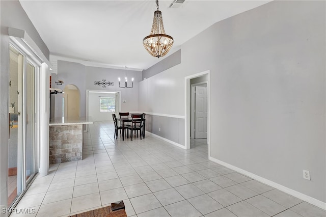 interior space with light tile patterned floors, arched walkways, a chandelier, and visible vents