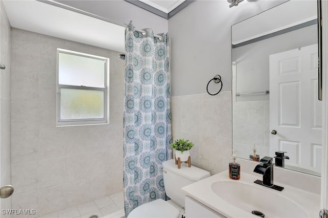 full bathroom featuring toilet, tile walls, tiled shower, and vanity