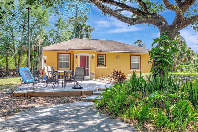 view of front of property with a wooden deck and stucco siding
