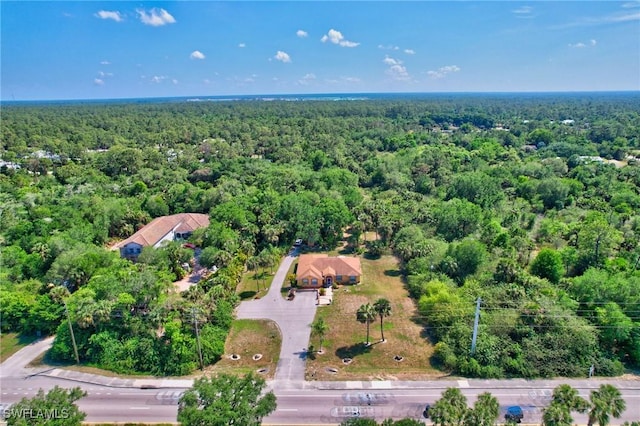 drone / aerial view with a wooded view