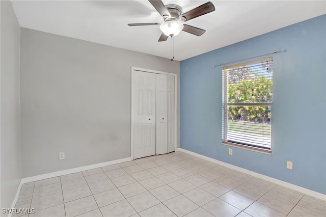 spare room featuring baseboards and a ceiling fan
