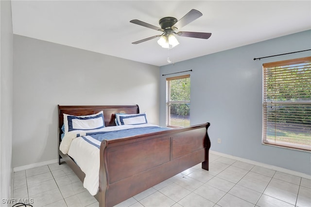 bedroom with light tile patterned floors, baseboards, and a ceiling fan