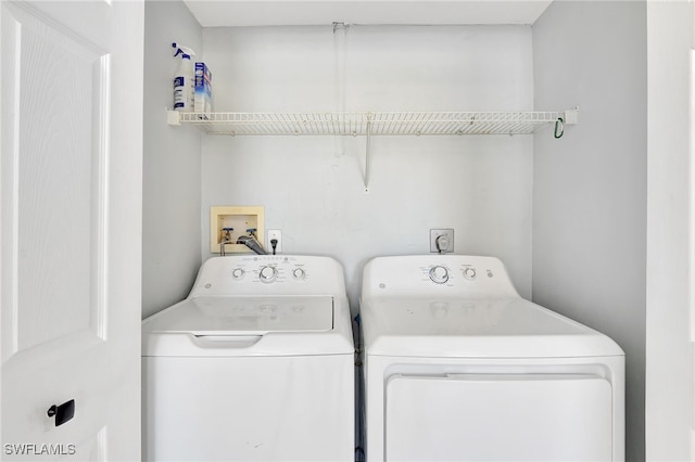 clothes washing area featuring washing machine and dryer and laundry area