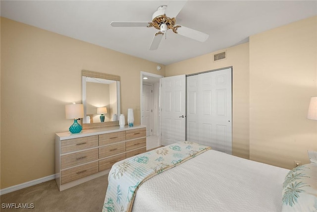 bedroom featuring a closet, baseboards, light carpet, visible vents, and ceiling fan