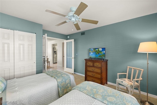 bedroom with stainless steel fridge with ice dispenser, a closet, baseboards, a ceiling fan, and visible vents