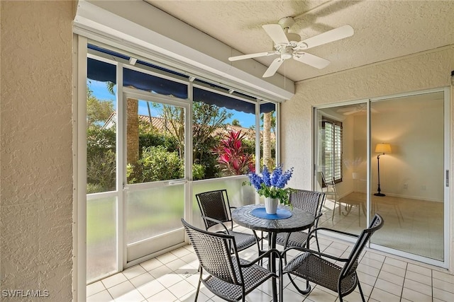 sunroom featuring a ceiling fan
