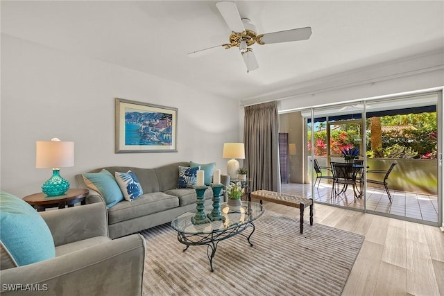 living area featuring a ceiling fan and wood finished floors