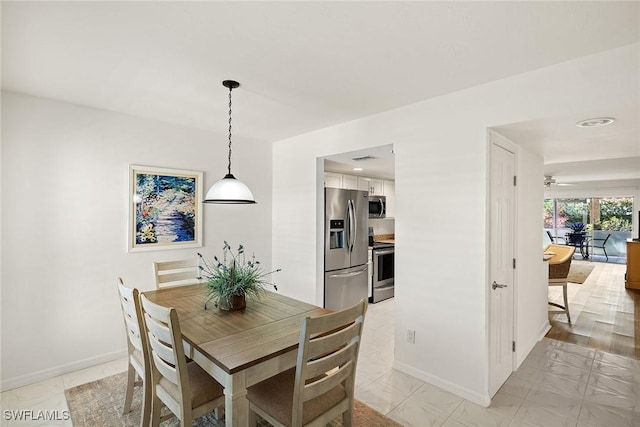 dining space featuring baseboards