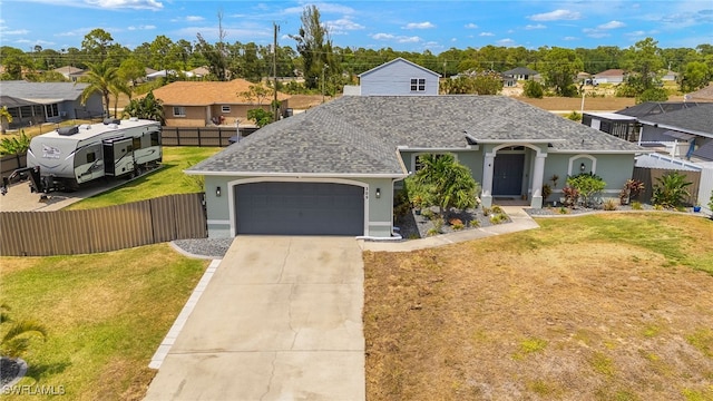 single story home with a residential view, a front lawn, a garage, and fence