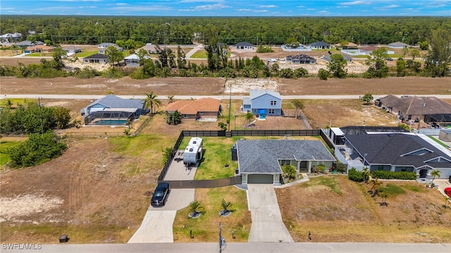 birds eye view of property with a residential view and a view of trees