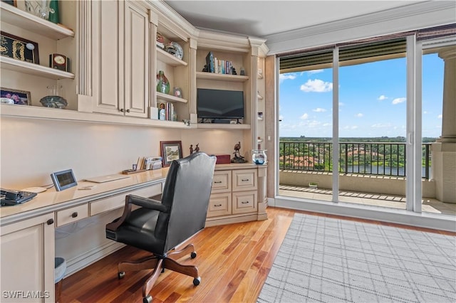 8787 Bay Colony Dr Unit 803, Naples, FL 34108 - home office featuring built in desk, light wood-type flooring, and ornamental molding