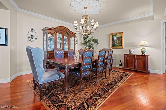 8787 Bay Colony Dr Unit 803, Naples, FL 34108 - dining space featuring a chandelier, ornamental molding, wood finished floors, and baseboards