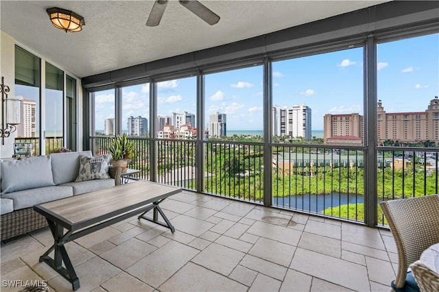 8787 Bay Colony Dr Unit 803, Naples, FL 34108 - sunroom featuring a view of city, ceiling fan, an outdoor hangout area, tile patterned flooring, and a textured ceiling