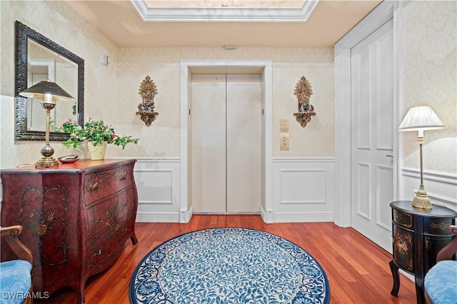 8787 Bay Colony Dr Unit 803, Naples, FL 34108 - foyer entrance with wood finished floors, elevator, a wainscoted wall, a decorative wall, and wallpapered walls