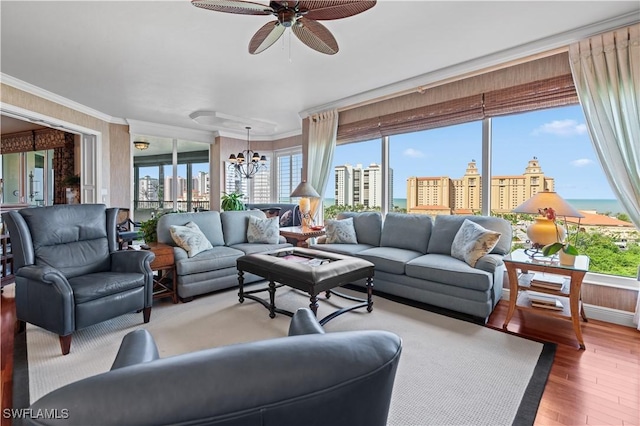 8787 Bay Colony Dr Unit 803, Naples, FL 34108 - living room featuring a view of city, ornamental molding, a chandelier, wood finished floors, and a ceiling fan
