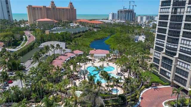 8787 Bay Colony Dr Unit 803, Naples, FL 34108 - aerial view of property and surrounding area featuring a large body of water, a pool, and nearby urban area