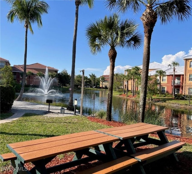 exterior space with a water view and a lawn