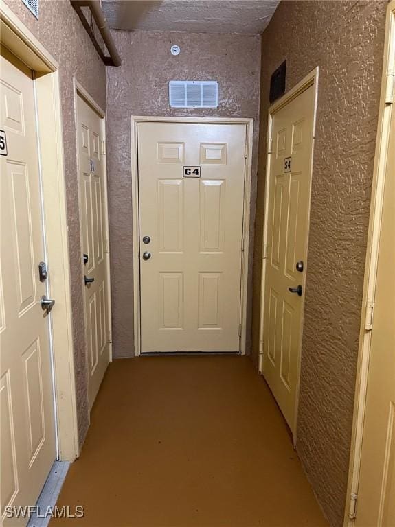 entryway featuring visible vents and a textured wall