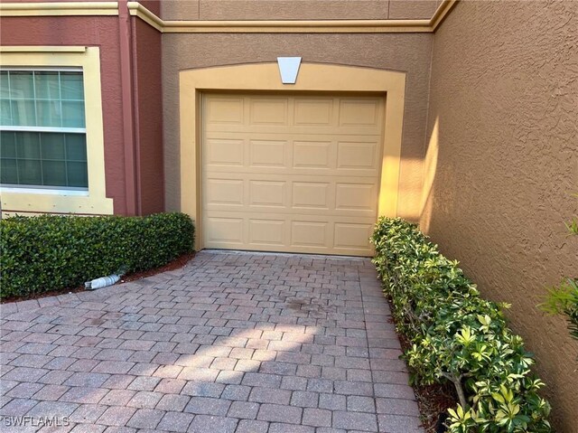 garage with decorative driveway