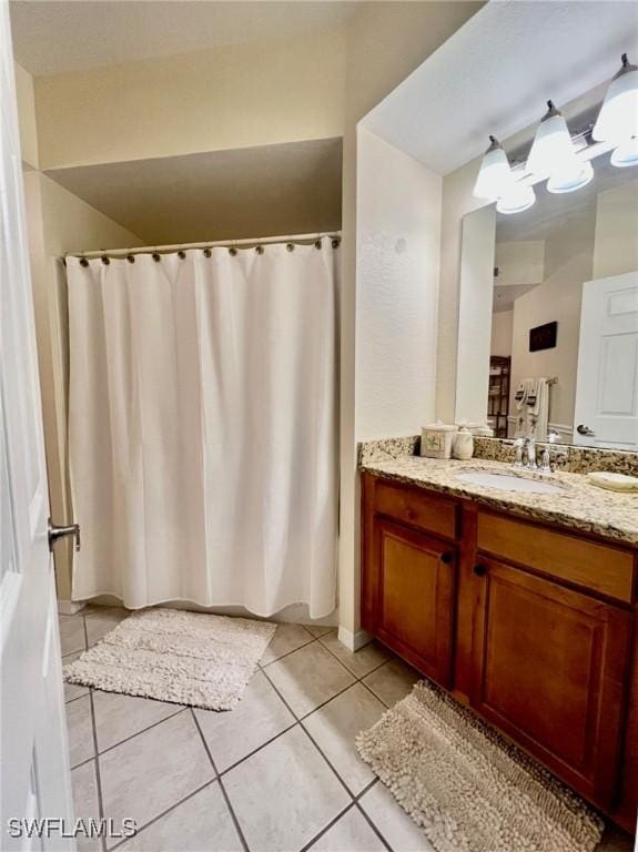 bathroom featuring tile patterned flooring, vanity, and a chandelier