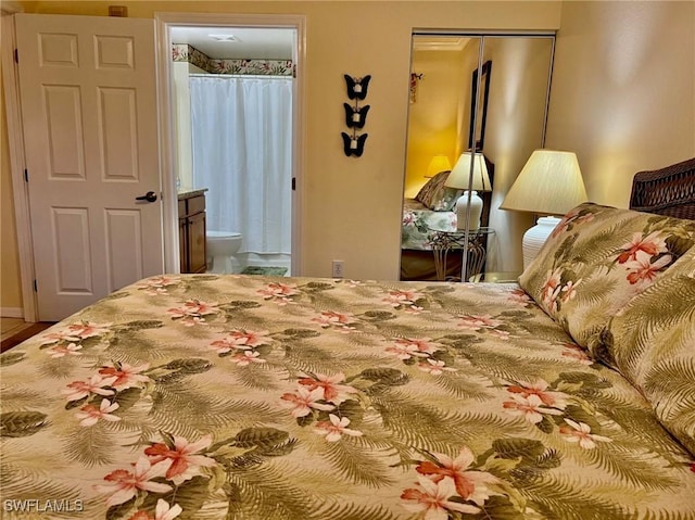 bedroom with a closet and ensuite bath