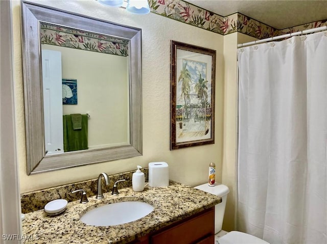 full bathroom with toilet, vanity, and a shower with curtain