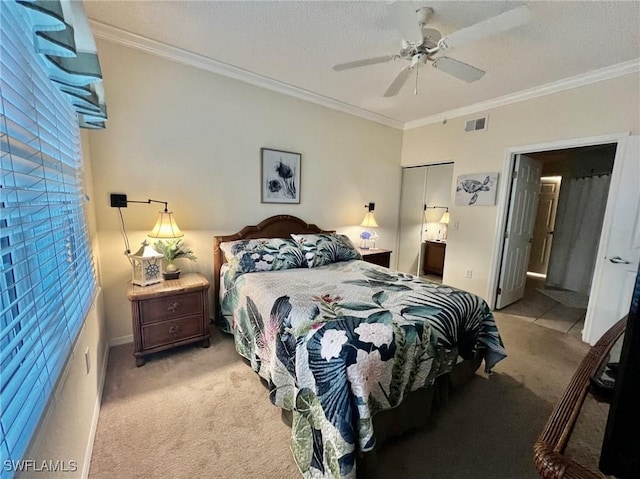 bedroom featuring a ceiling fan, ornamental molding, ensuite bath, visible vents, and light carpet