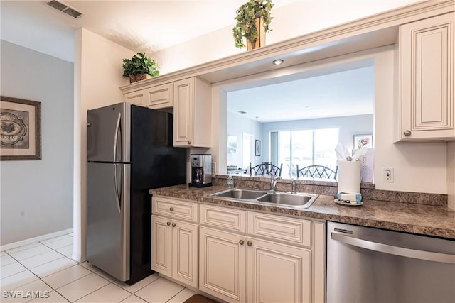 14500 Daffodil Dr Unit 1102, Fort Myers, FL 33919 - kitchen with light tile patterned floors, visible vents, cream cabinetry, a sink, and stainless steel appliances