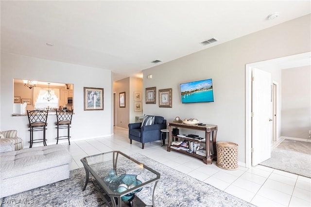 14500 Daffodil Dr Unit 1102, Fort Myers, FL 33919 - living area featuring light tile patterned floors, a chandelier, and baseboards