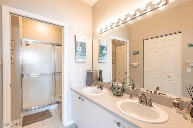 14500 Daffodil Dr Unit 1102, Fort Myers, FL 33919 - bathroom with toilet, double vanity, tile patterned flooring, and a shower stall