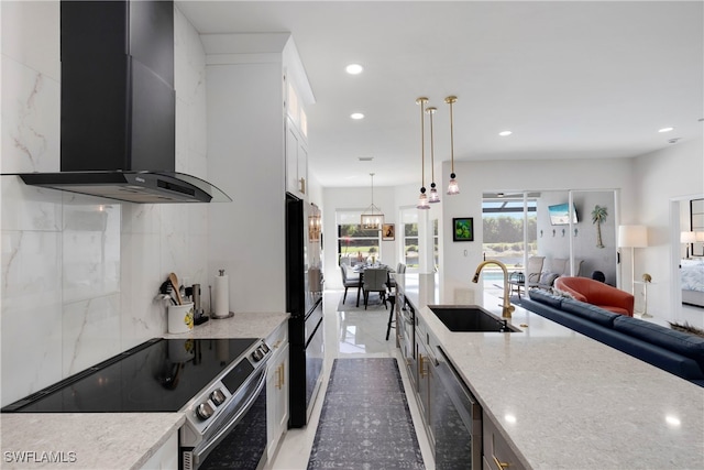 26036 Clarkston Dr, Bonita Springs, FL 34135 - kitchen with wall chimney range hood, electric stove, dishwasher, freestanding refrigerator, and light stone counters