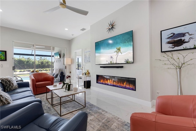 26036 Clarkston Dr, Bonita Springs, FL 34135 - living area featuring marble finish floors, a glass covered fireplace, a ceiling fan, and recessed lighting