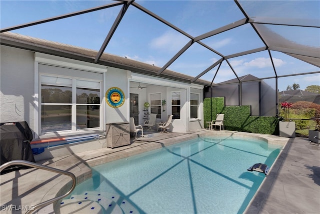 26036 Clarkston Dr, Bonita Springs, FL 34135 - outdoor pool featuring a patio, a ceiling fan, and glass enclosure