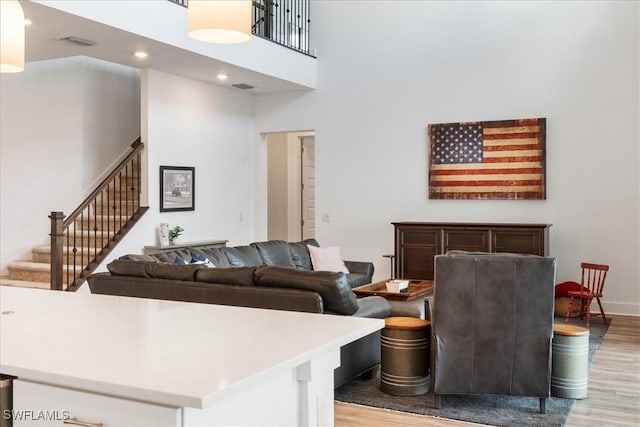 4151 Traditions Dr, Ave Maria, FL 34142 - living area featuring stairs, light wood finished floors, visible vents, and a high ceiling