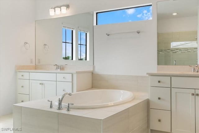 4151 Traditions Dr, Ave Maria, FL 34142 - bathroom featuring two vanities, a sink, a garden tub, and a healthy amount of sunlight