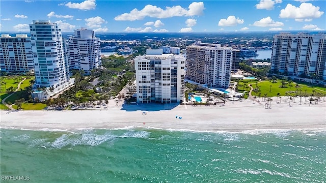 birds eye view of property with a beach view, a water view, and a view of city