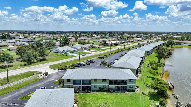 drone / aerial view with a residential view and a water view