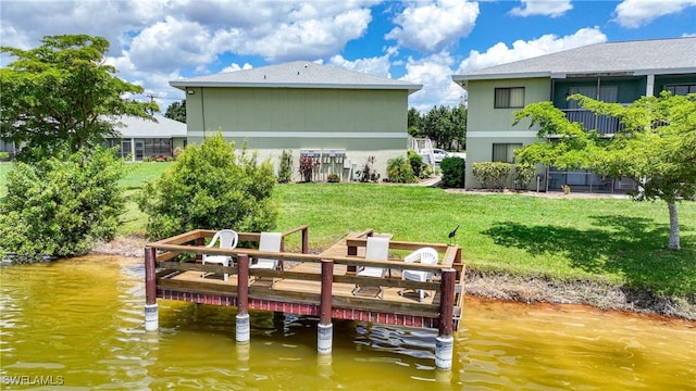 rear view of property with a yard and a water view