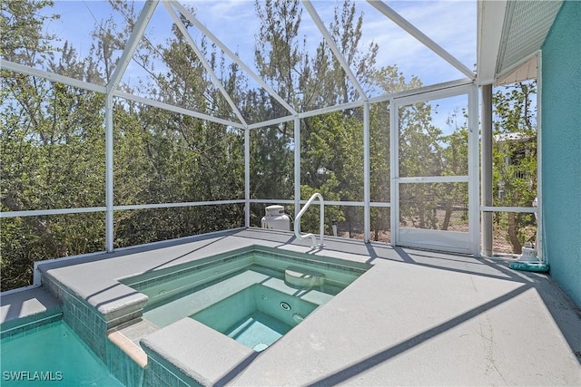 3852 Stabile Rd, Saint James City, FL 33956 - view of swimming pool featuring a patio area, an in ground hot tub, and glass enclosure