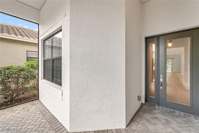 11643 Riverstone Ln, Fort Myers, FL 33913 - doorway to property with stucco siding and a tile roof